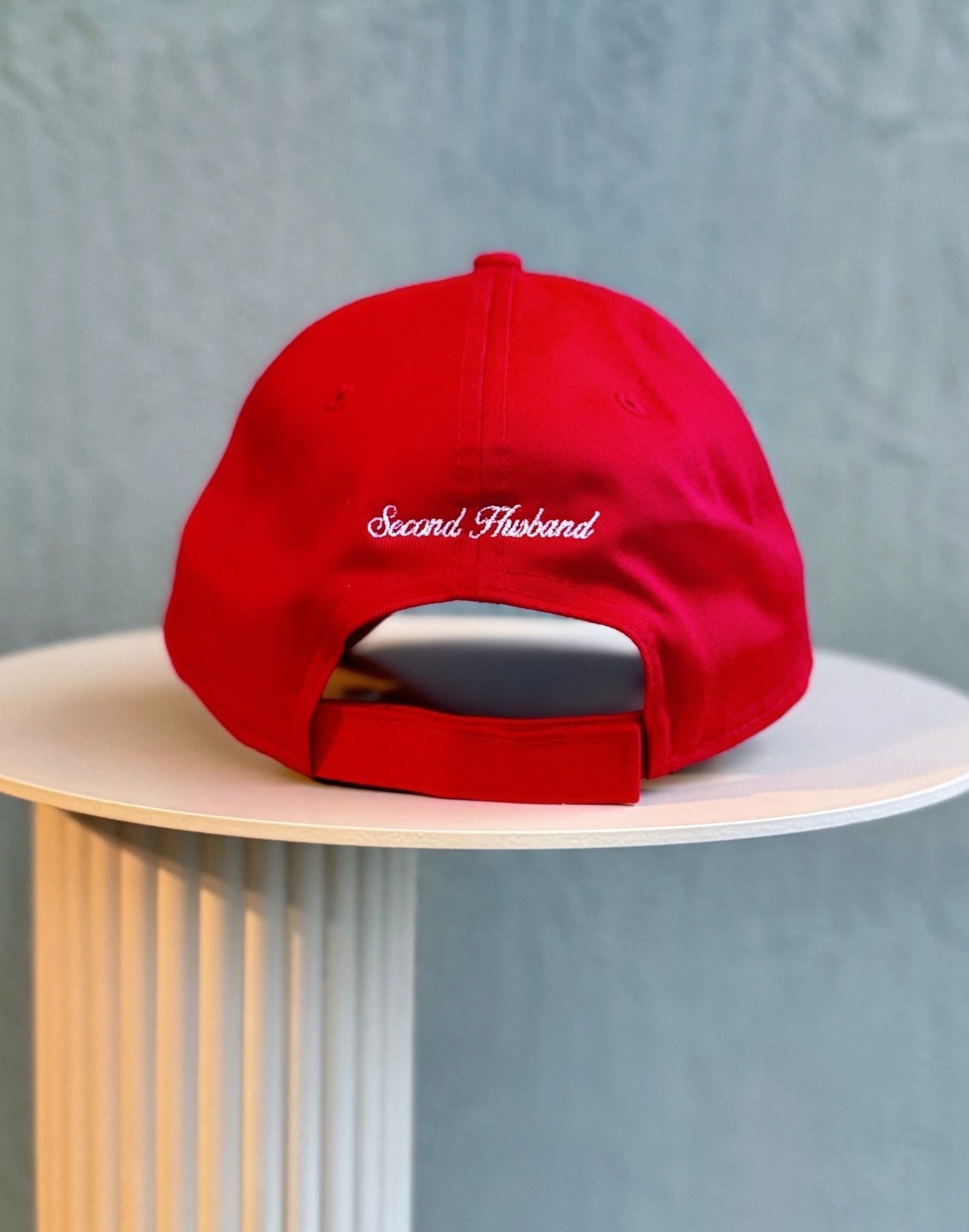Red cap with 'Second Hand' text on a light gray background