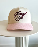 Cap with 'Second Wife' text on a white surface