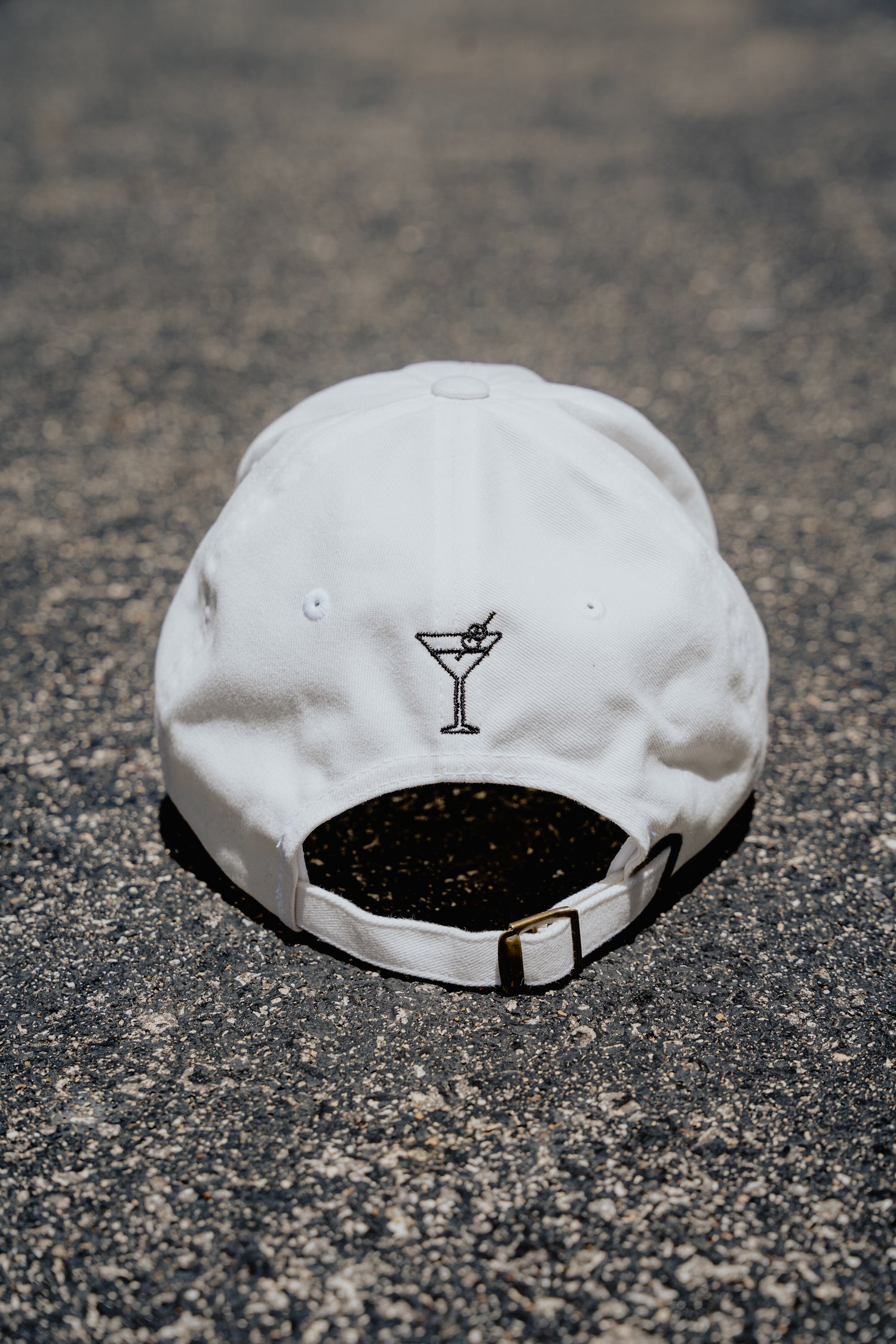 White cap with a black logo on a textured surface