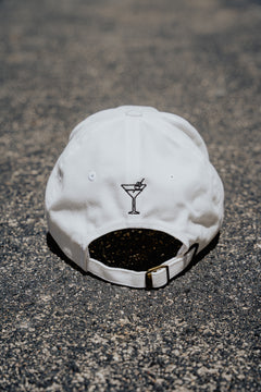 White cap with a black logo on a textured surface